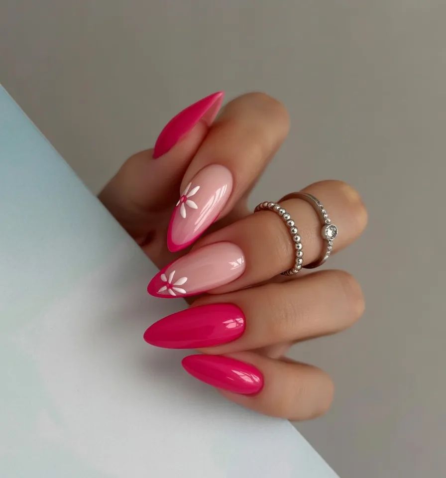 Bright pink and red almond nails with daisies