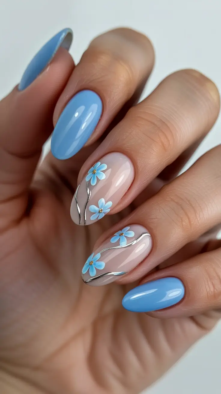 chic pretty spring nails design 2026 Baby blue florals with silver flowing accents